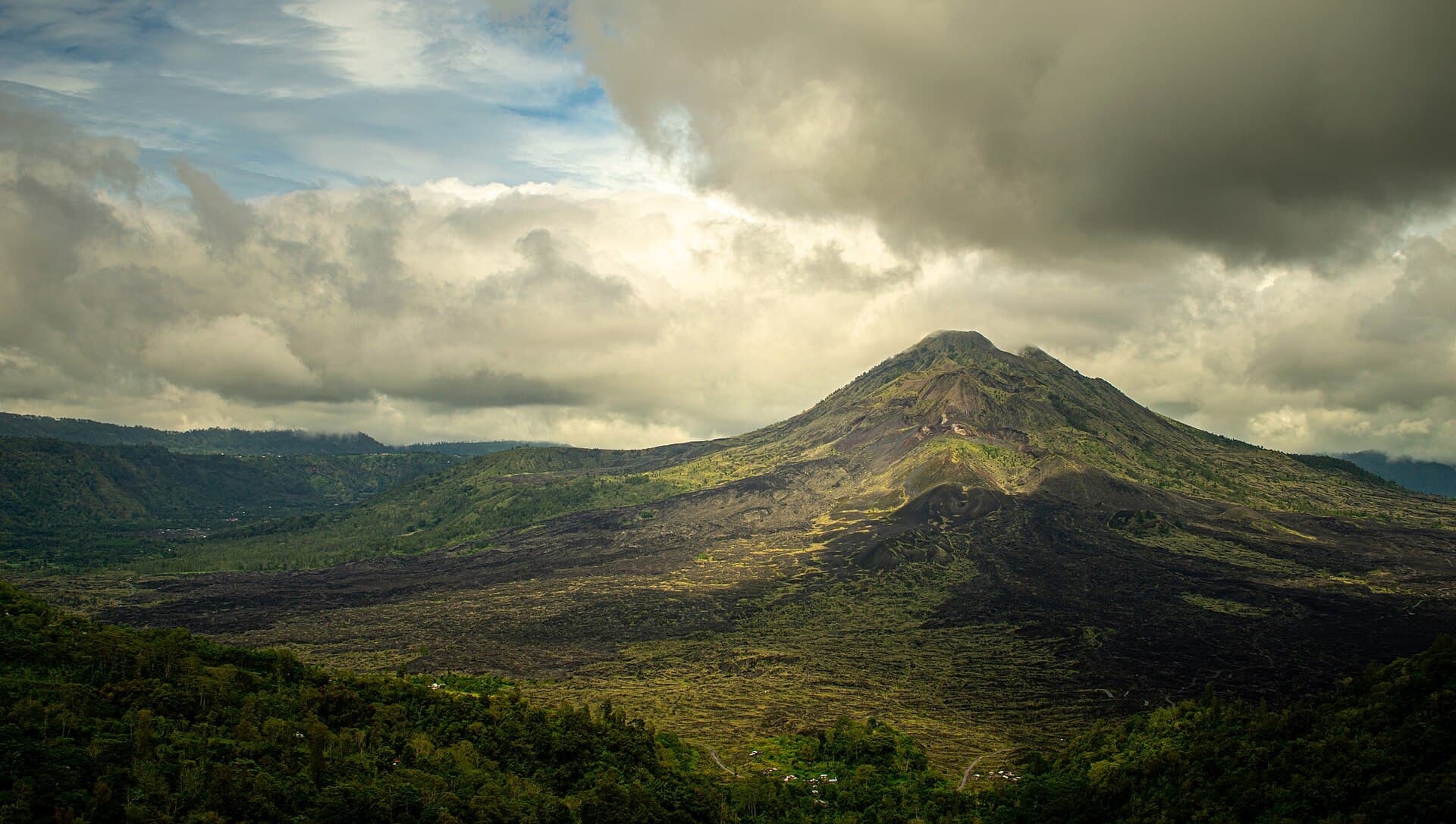 The cone of Mount Batur rising above its old lava field, seen from Kintamani