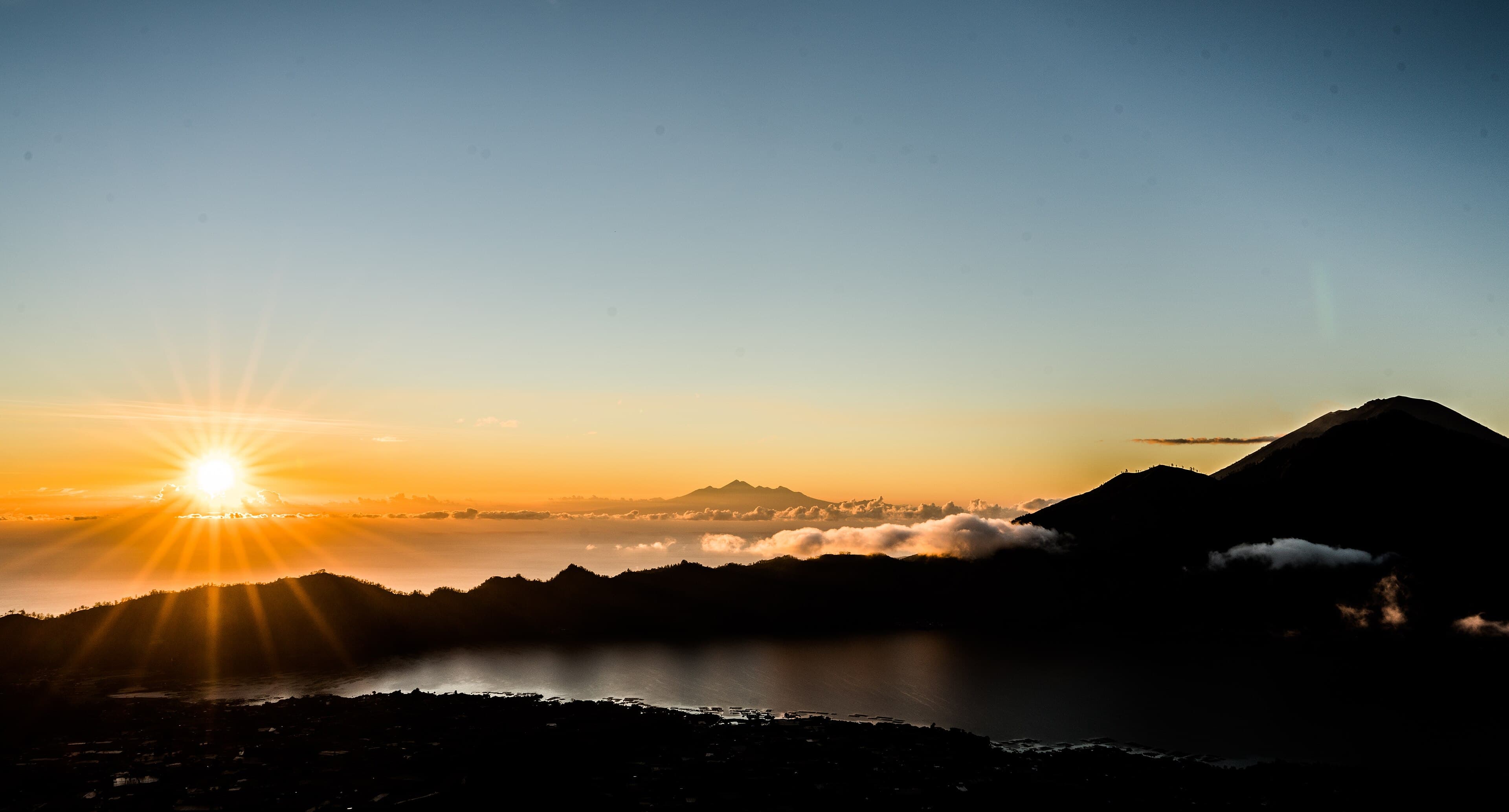 Sunrise seen from the summit of Mount Batur, looking across Lake Batur towards Mount Rinjani